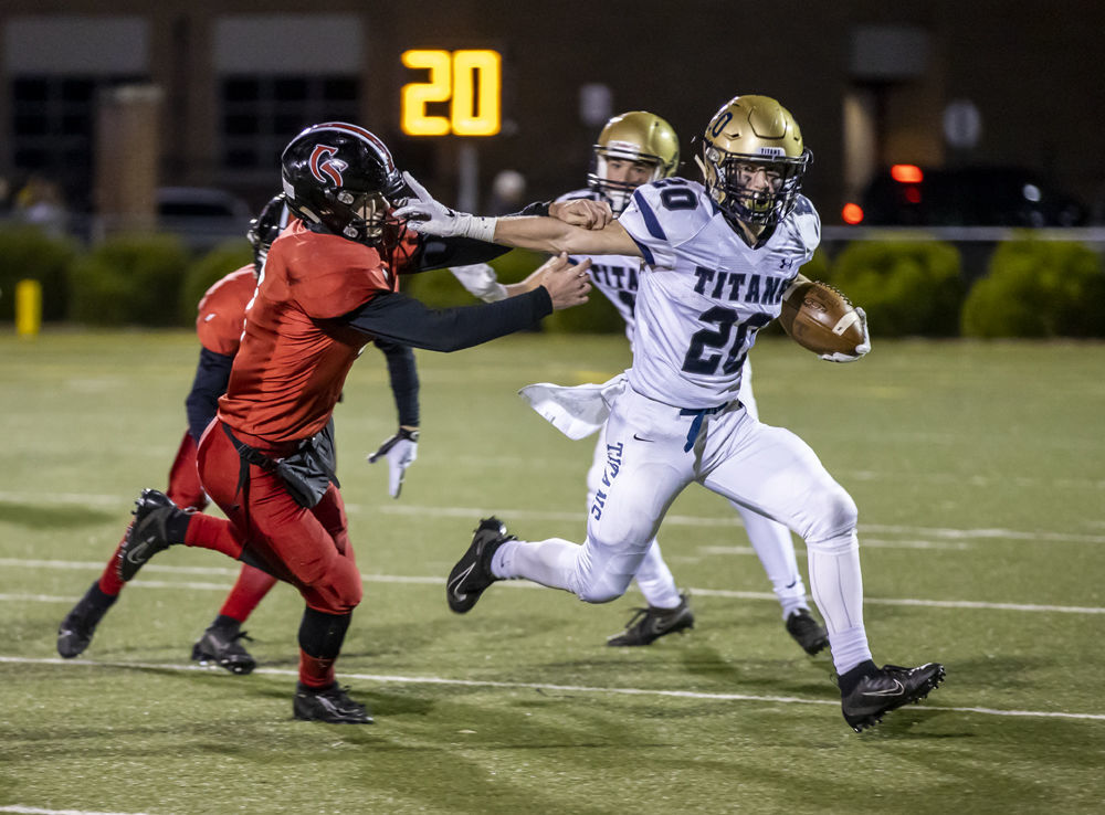 Hidden Valley's (20) Matt Strong gives a stiff-arm to Cave Spring's (3) Lucas Duncan as he tries to bring him down.